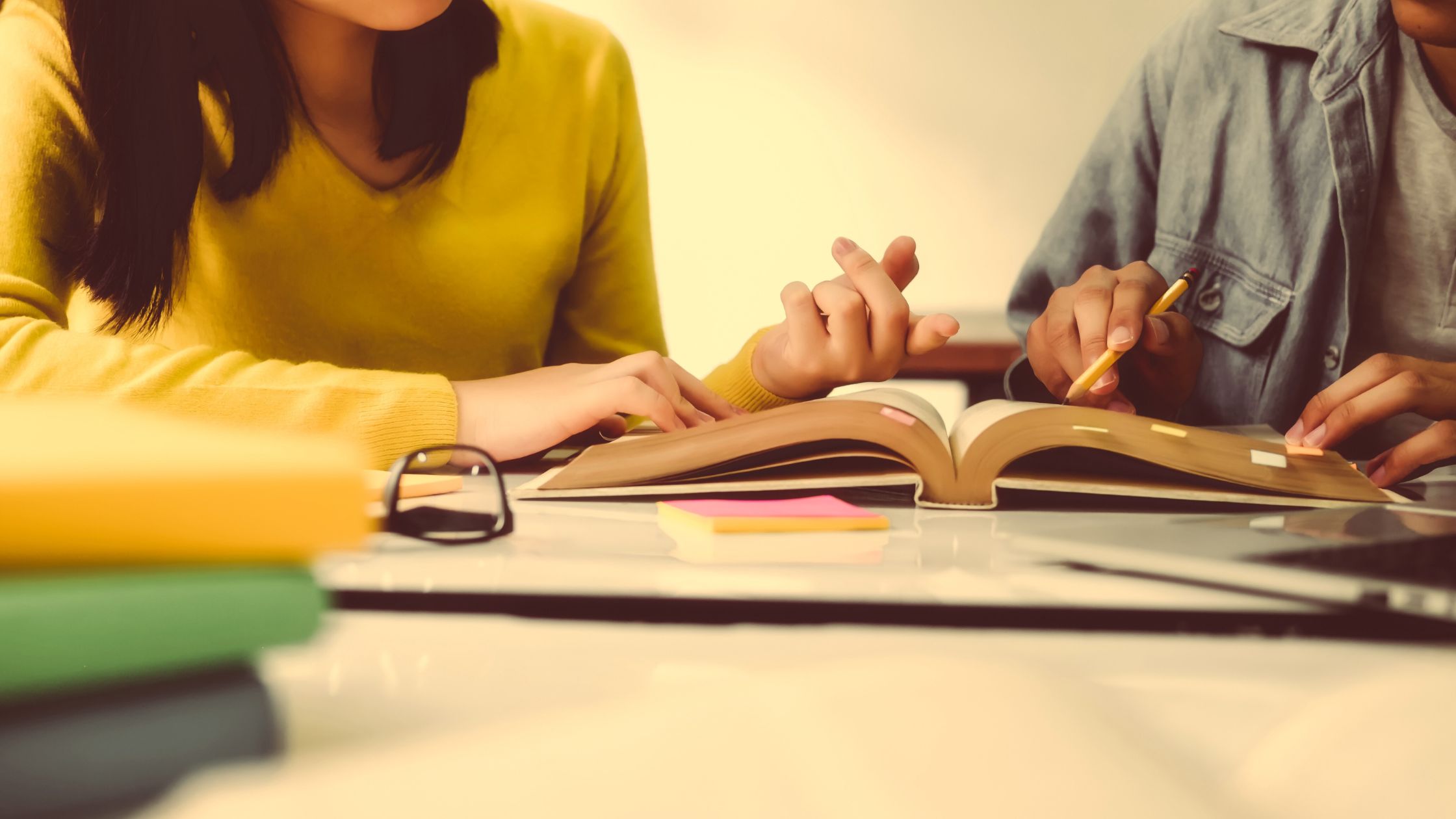 teacher-and-students-working-by-desk